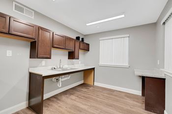 an empty kitchen with a sink and a window