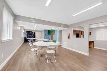 a dining room with a table and chairs