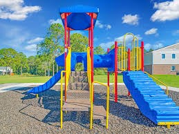 A playground with a blue slide and yellow supports.