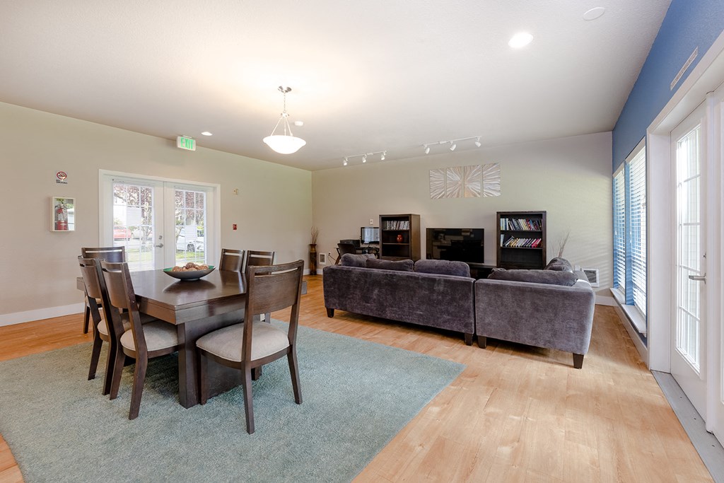 a living room with a dining table and a couch