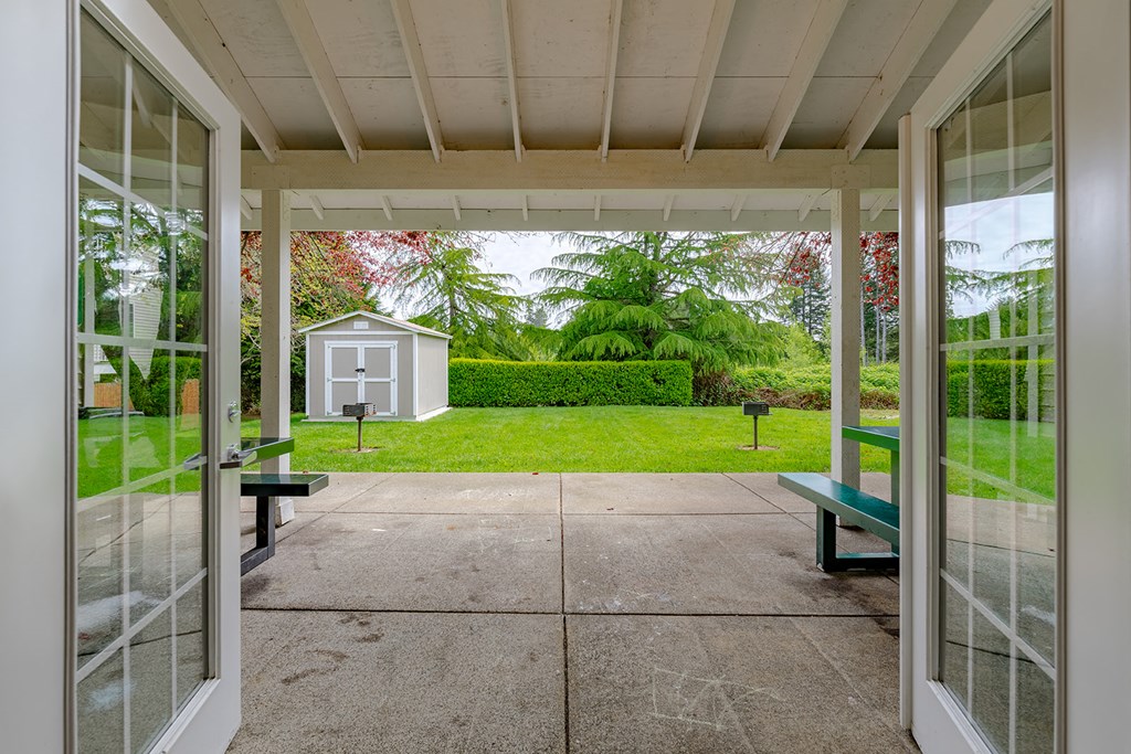 a view of the yard from a porch with glass doors