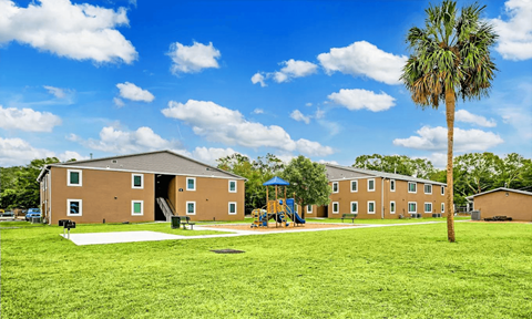 A large building with a playground in front of it.