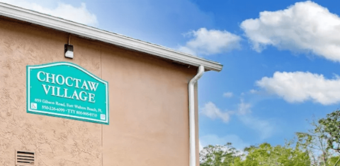 A sign on a building that says Choctaw Village.