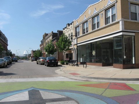 A street with a crosswalk and a building on the right.