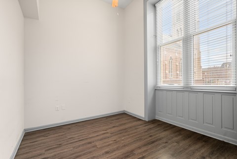 Empty room with wooden floor and white walls.