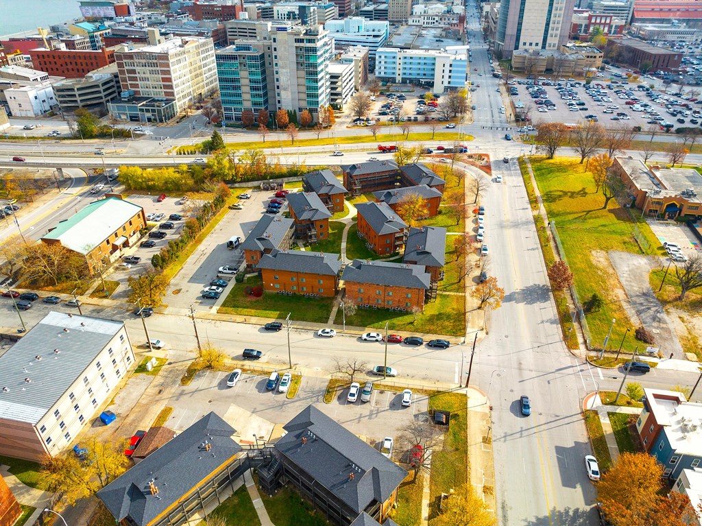 an aerial view of a city with buildings and cars