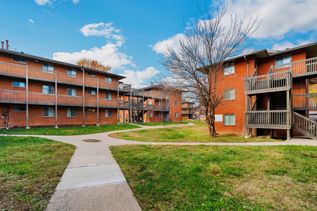 our apartments have a spacious courtyard with sidewalk paths and grass