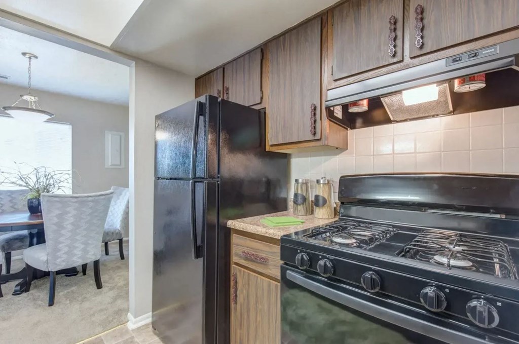 a kitchen with wooden cabinets and stainless steel appliances