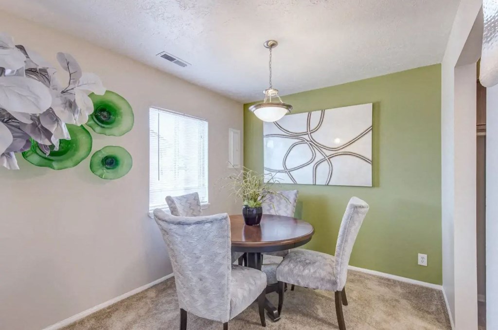 a dining room with a table and chairs