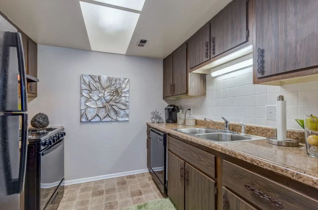 a kitchen with wooden cabinets and stainless steel appliances