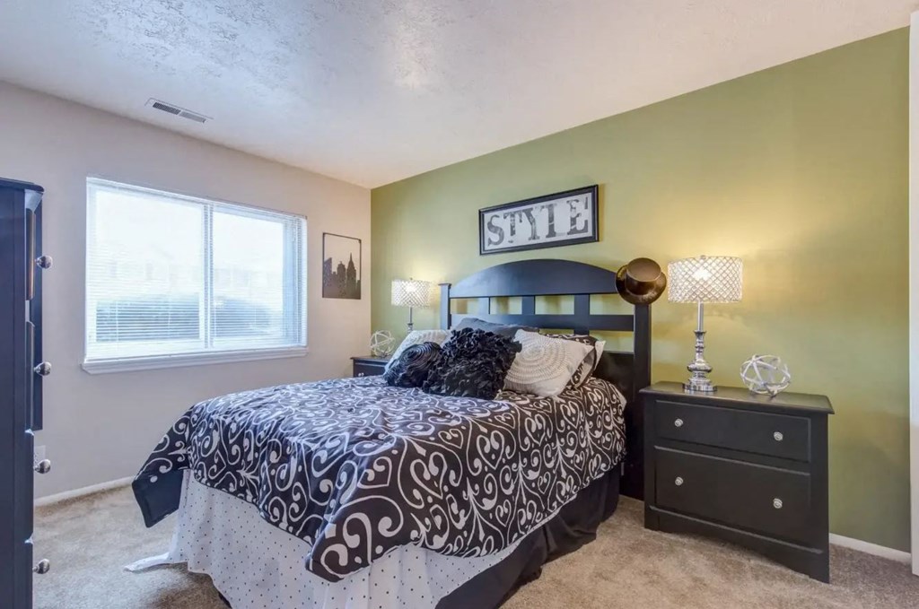 a bedroom with a bed and a dresser