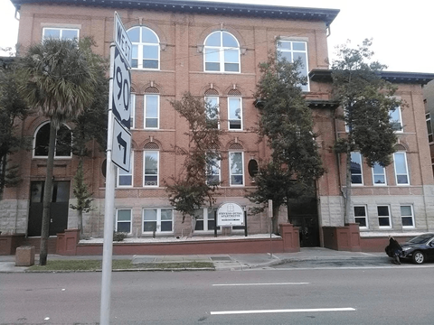 A brick building with a sign that says "1951" on it.