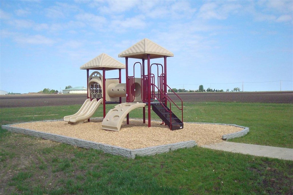A playground with a slide, swings, and a sandbox.
