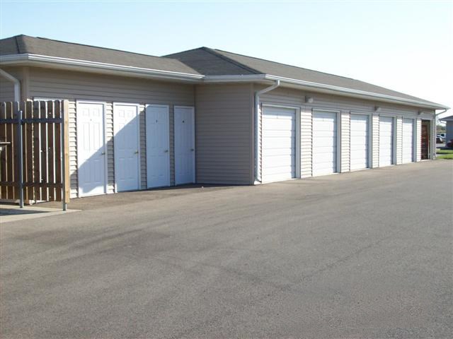 A long building with a fence in front of it.