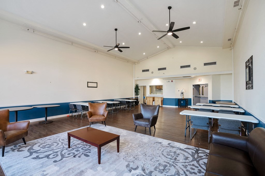 a large room with tables and chairs and a lounge area