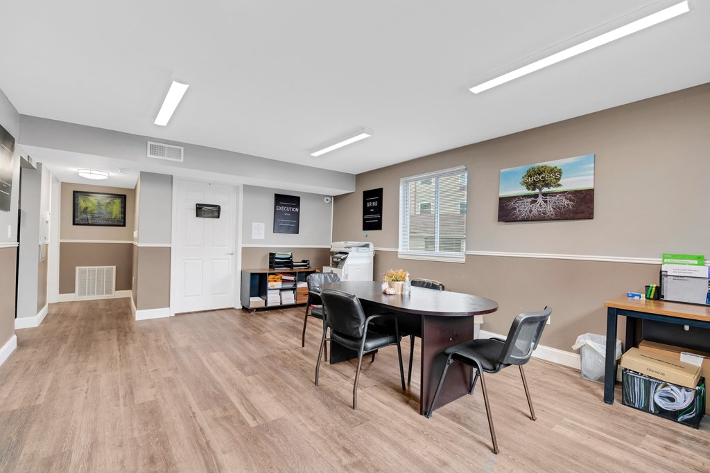 a break room with a table and chairs and a window