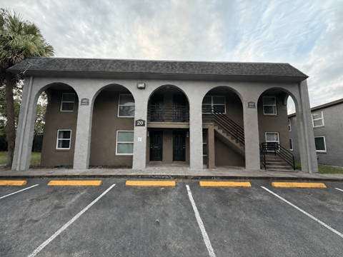 A building with a parking lot in front of it.