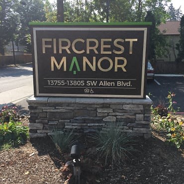 a sign for the fireiest manor on the side of a road