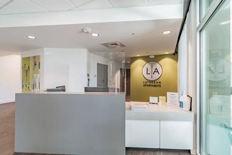 a reception area with a counter and a glass window