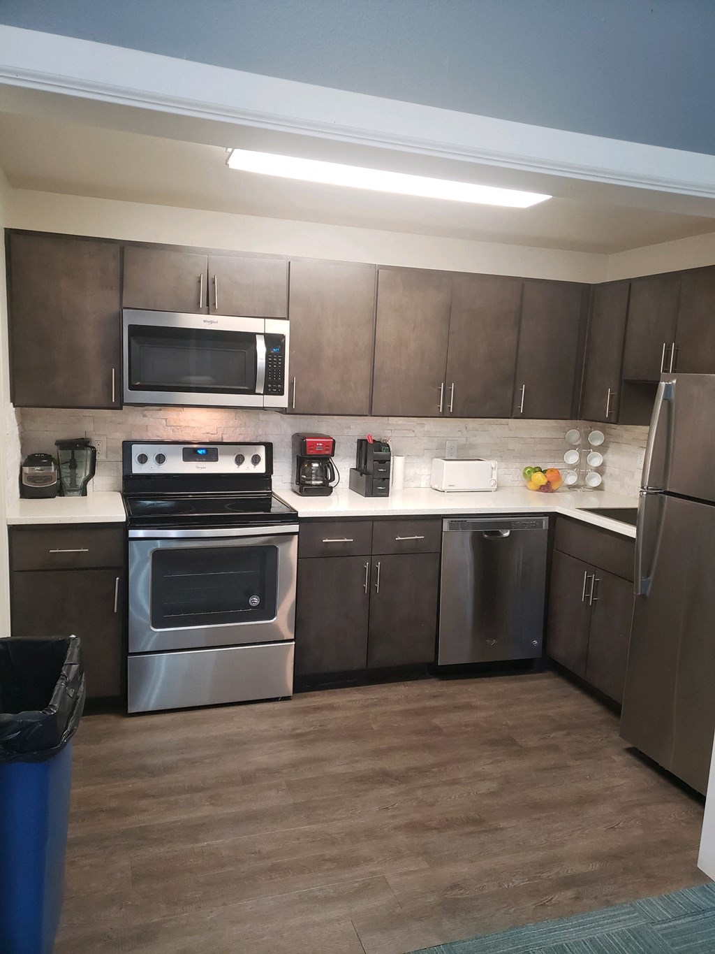 a kitchen with stainless steel appliances and wooden cabinets