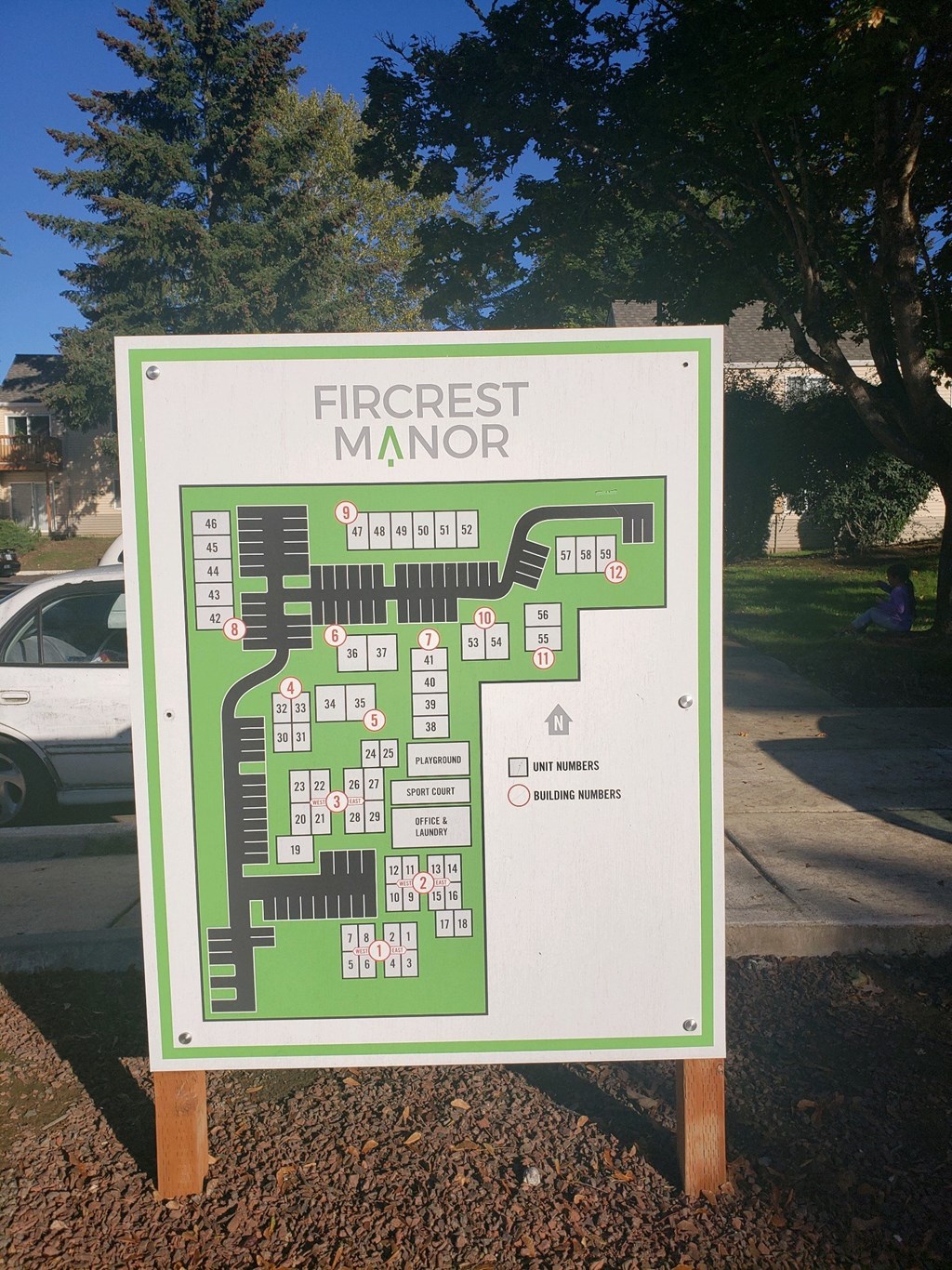 a sign for the firecracker manor site on a sidewalk