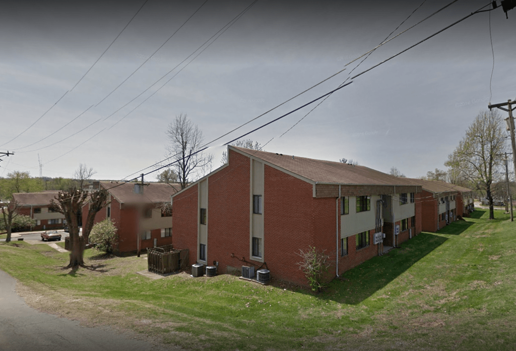 a red brick building with a street in front of it