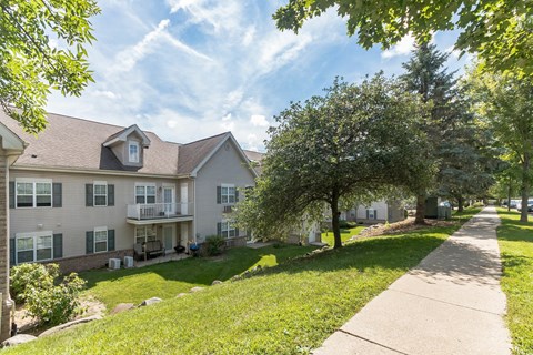 A sunny day at a residential area with apartment buildings and green lawns.