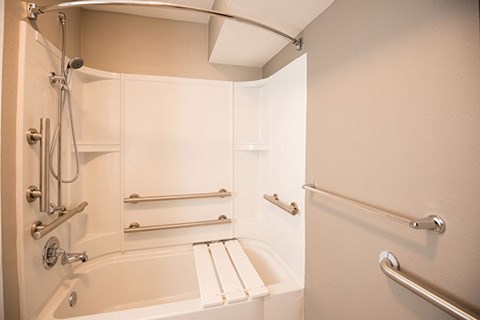A white bathroom with a tub and shower.