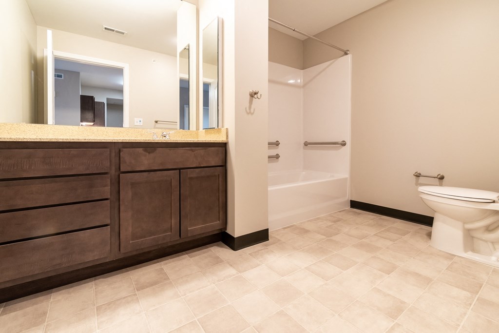 a bathroom with a toilet and a sink and a bath tub