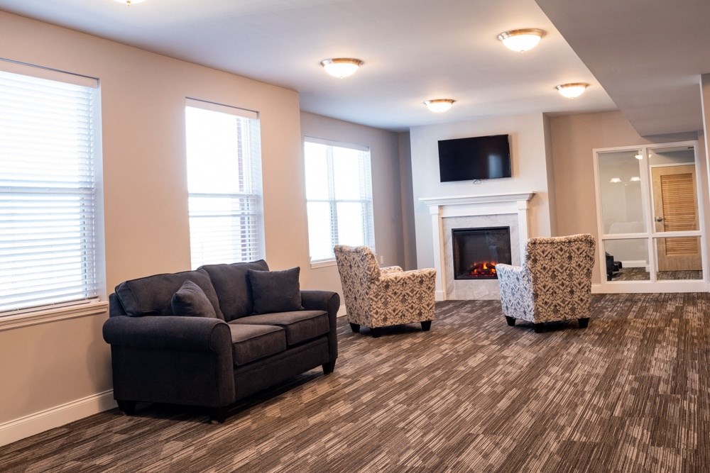 a living room with couches and chairs and a fireplace