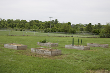 a group of concrete planters in the grass