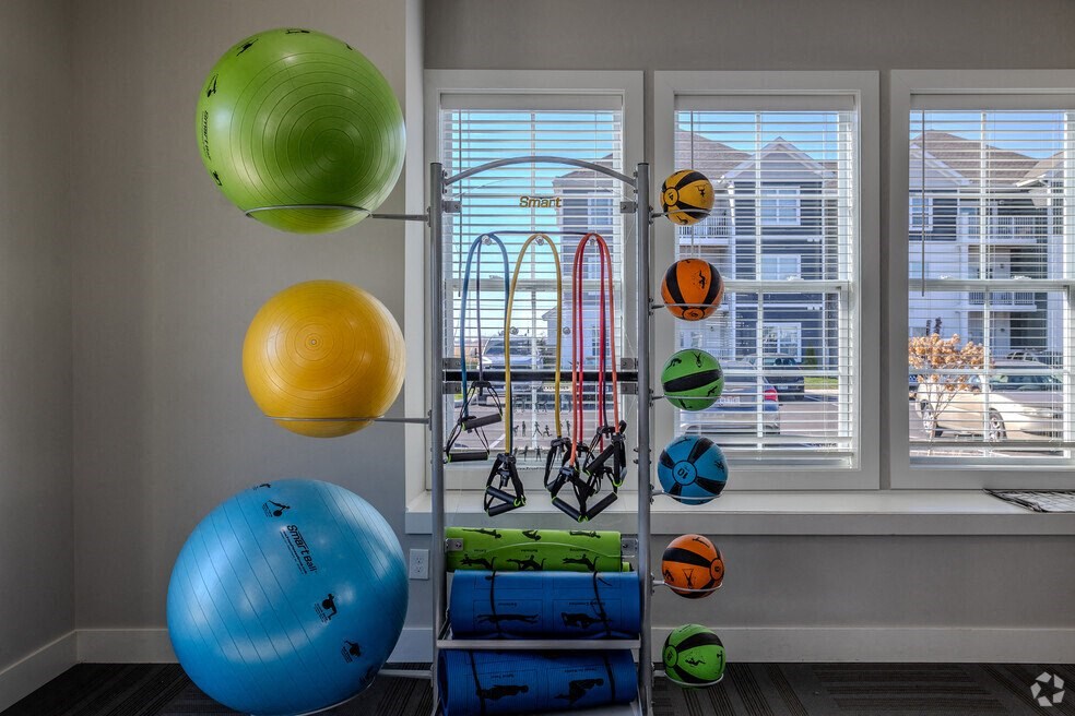 a room with a bunch of balloons and a window