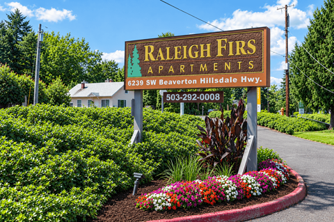 A sign for Raleigh Firs Apartments is displayed in front of a house.
