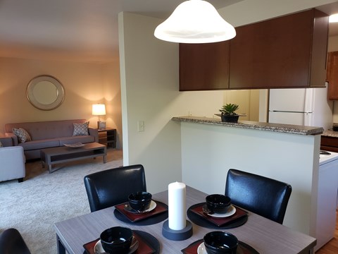 A dining room with a table set for two.