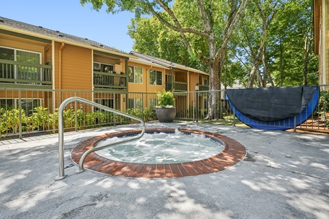 A hot tub sits in the middle of a patio.