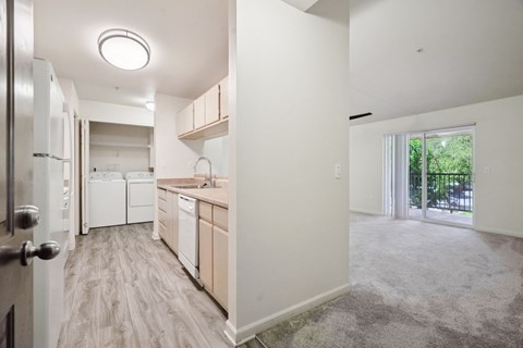 A kitchen with white appliances and wooden cabinets.