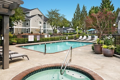 A pool with a hot tub in the middle of it.