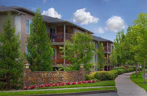 A row of houses with a sign that says Hawks Ridge.