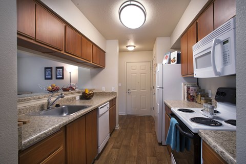 A kitchen with wooden cabinets and white appliances.