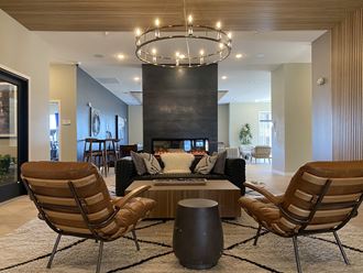 a large living room with a fireplace and a chandelier