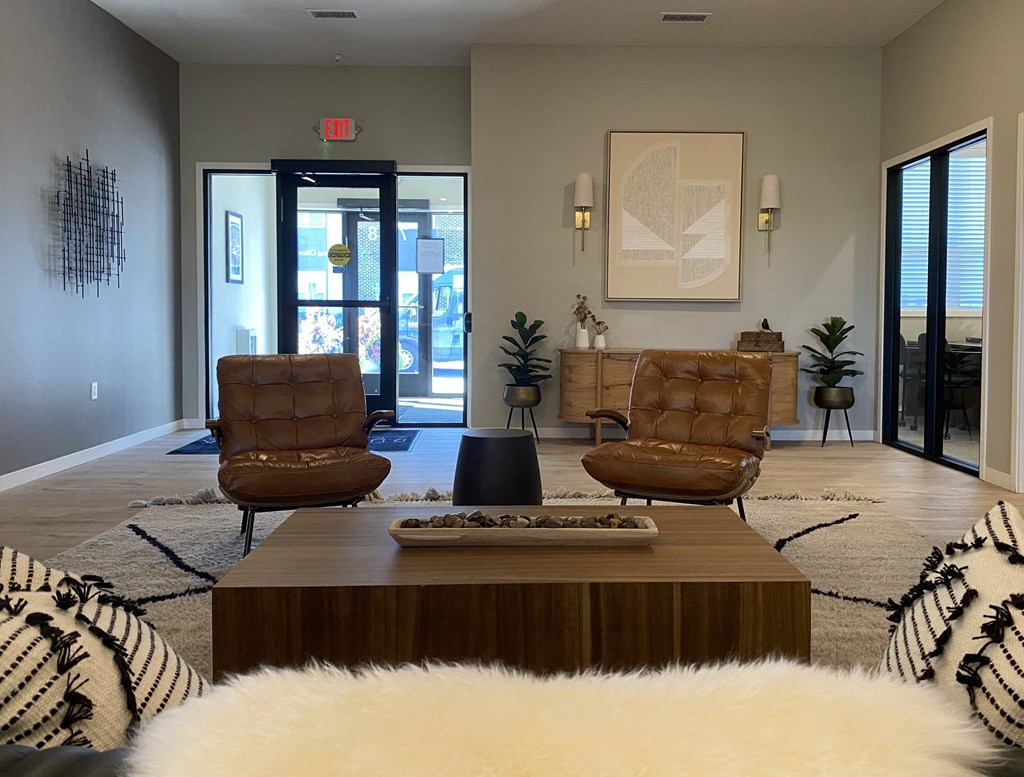 a living room with a coffee table and chairs