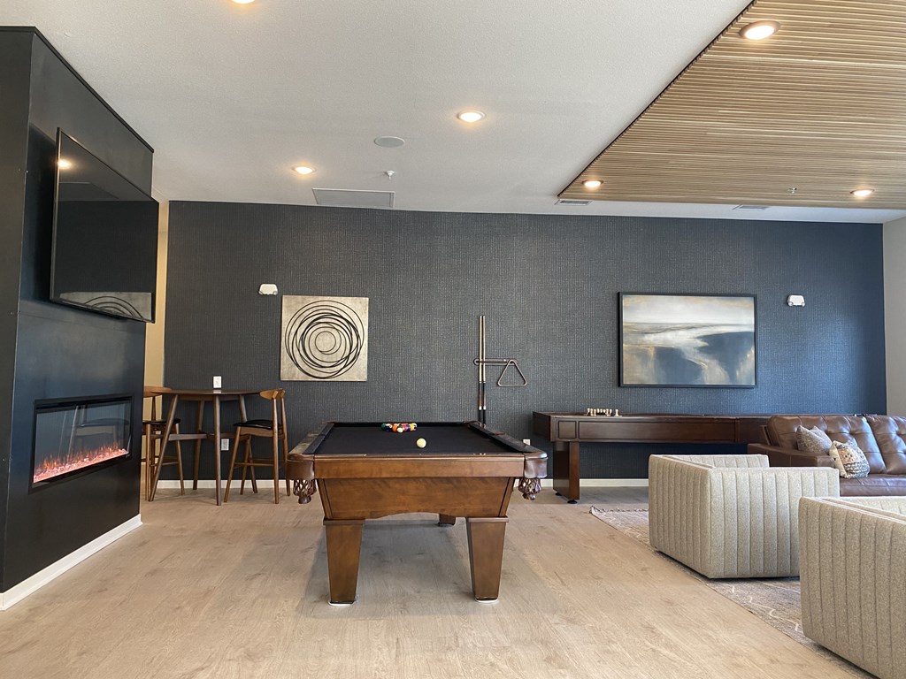a game room with a pool table and a flat screen tv
