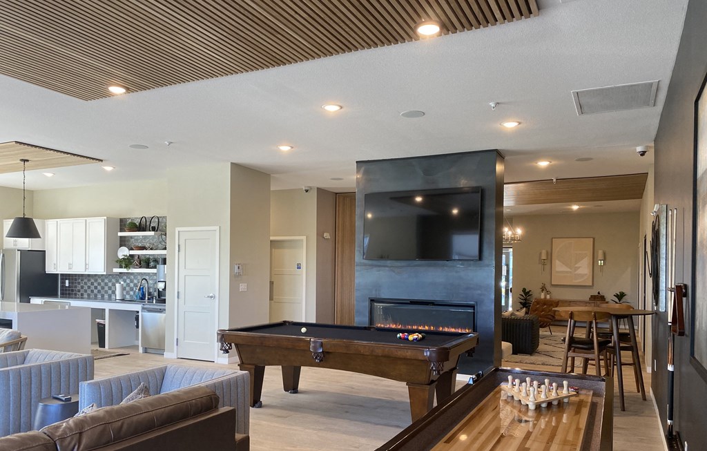 a living room with a pool table and a flat screen tv