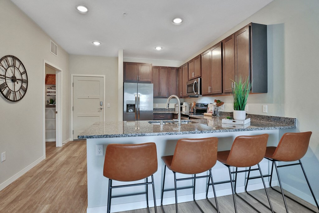 a kitchen with a large island with a breakfast bar