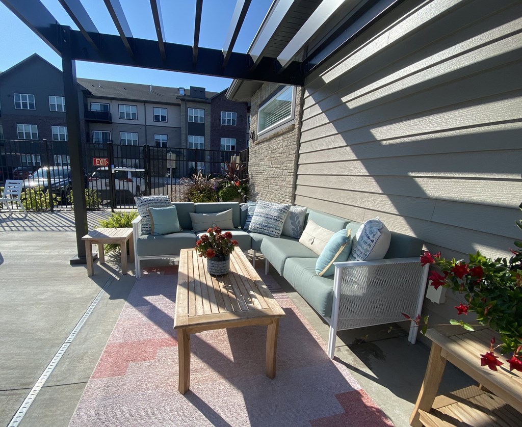 a patio with couches and a coffee table