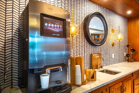 a kitchen with a refrigerator and a sink and a mirror