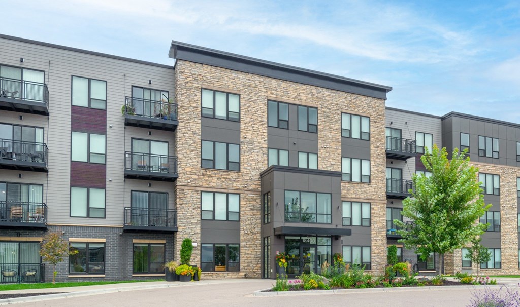 an exterior view of an apartment building with windows and balconies