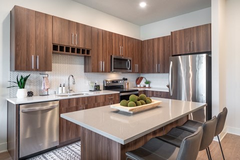 a kitchen with stainless steel appliances and a white counter top