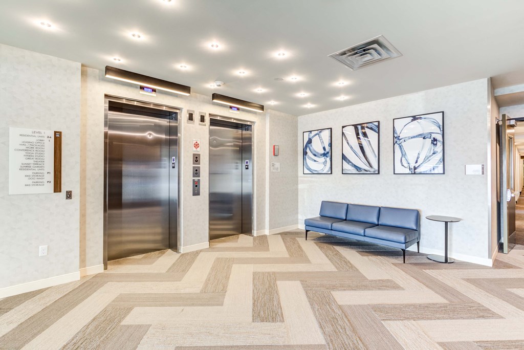 a view of the elevators and a checkered floor in front of them