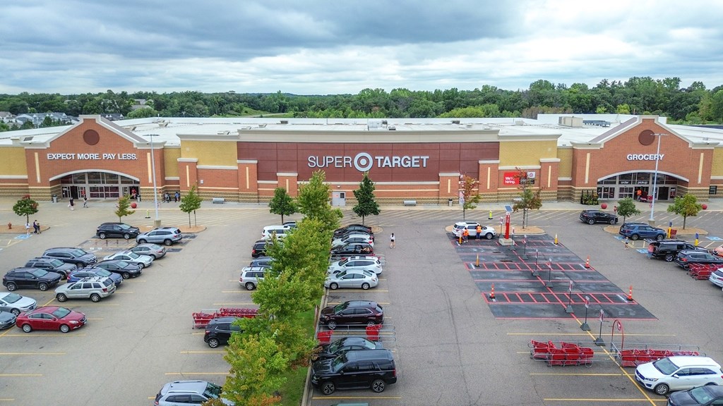a parking lot in front of a shopping center with cars parked